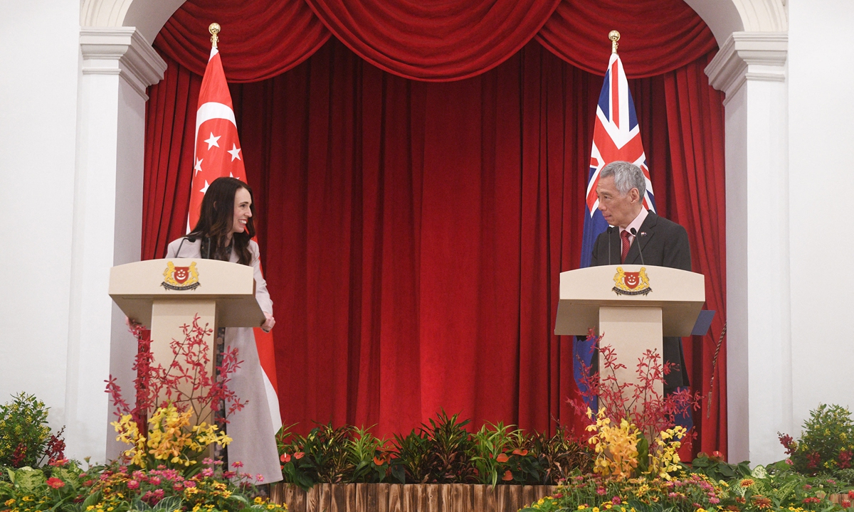 New Zealand's Prime Minister Jacinda Ardern (left) smiles at her Singaporean counterpart Lee Hsien Loong during a joint press conference at the Istana presidential palace in Singapore on April 19, 2022. Lee said the two countries will be working more closely on the green economy and the fight against climate change, The Strait Times reported. Photo: AFP