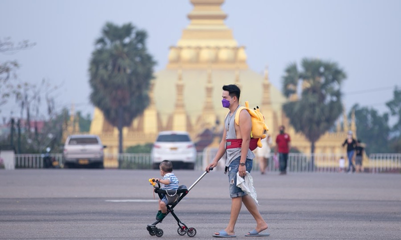People walk on the That Luang Square in the downtown of the Lao capital Vientiane, April 10, 2022.(Photo: Xinhua)