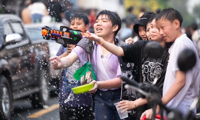 People splash water to each other to celebrate the Songkran Festival, or the Lao New Year, in Luang Prabang, Laos, April 15, 2022. Laos celebrated Songkran from April 14 to 16.(Photo: Xinhua)