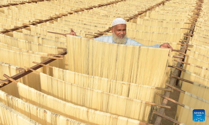 A man arranges rice vermicelli noodles ahead of Eid al-Fitr at a factory in Bogura, Bangladesh, April 17, 2022.(Photo: Xinhua)