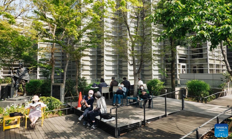 People read books in a park of the Suginami City Central Library in Tokyo, Japan, April 10, 2022. (Photo: Xinhua)
