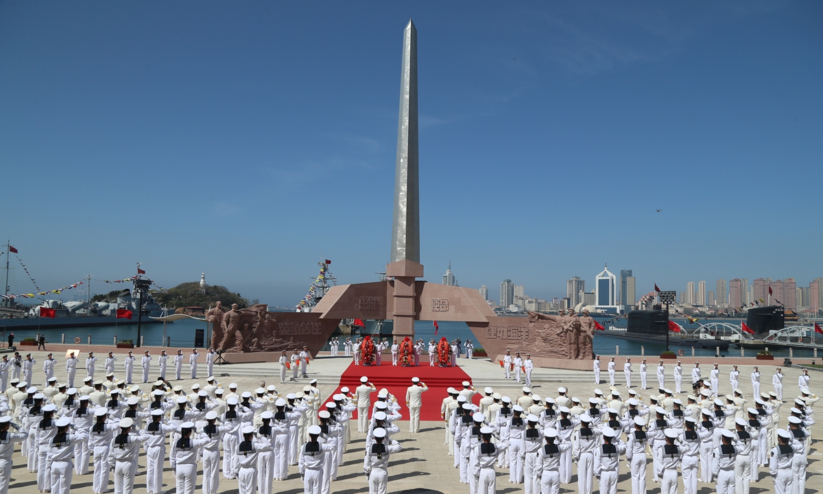 PLA Navy sailors attend a ceremony marking the Navy's 73rd founding anniversary on April 23, 2022, at the Naval Heroes Square of the Naval Museum in Qingdao, East China's Shandong Province. Docked on the bay are retired PLA Navy vessels. Photo: Chen Mengxi