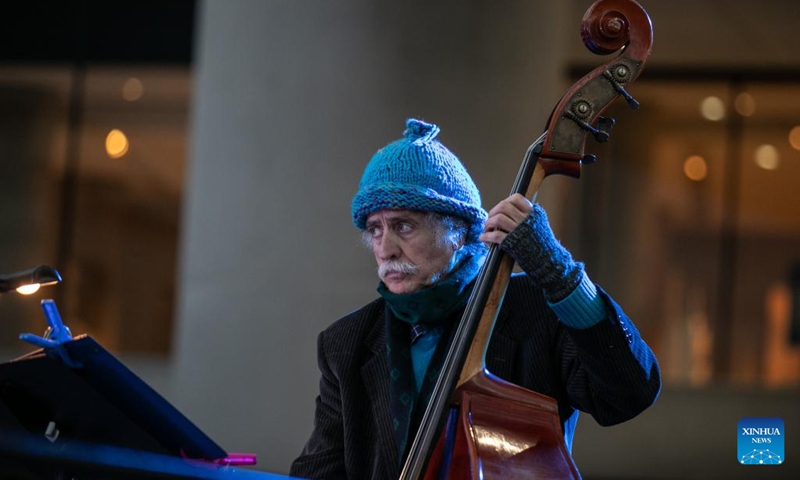 A musician performs in front of the Acropolis Museum during the first Sacred Music Festival in Athens, Greece, on April 19, 2022. The first Sacred Music Festival takes place at 17 landmarks in Athens from April 18 to April 20.(Photo: Xinhua)