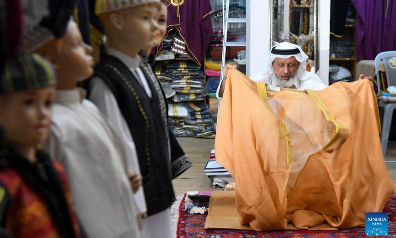 A tailor makes traditional dresses at a shop in preparation for the Eid al-Fitr festival in Doha, Qatar, April 19, 2022.(Photo: Xinhua)