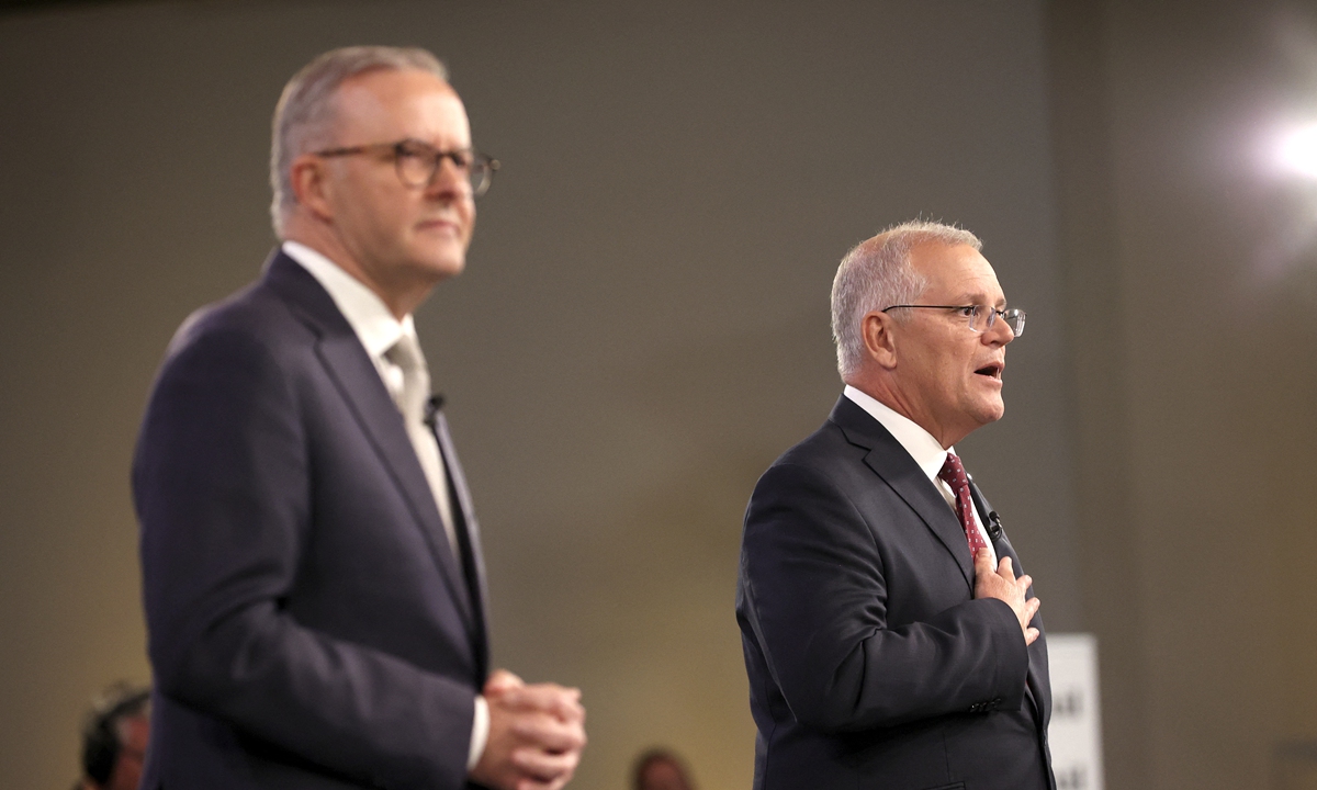 Leader of the Opposition Anthony Albanese (L) and Australian Prime Minister Scott Morrison attend the first leaders' debate of the 2022 federal election campaign at the Gabba on April 20, 2022 in Brisbane, Australia. 
