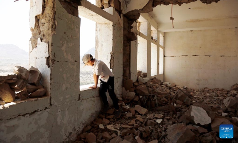 A Yemeni student is seen at the destroyed Shuhada-Alwahdah school in Al-Radhmah district, Ibb province, western Yemen, on April 12, 2022. Thousands of schools have been destroyed and abandoned in Yemen as a result of the civil war, according to teacher's unions, which warn that illiteracy among the younger generation is on the rise and the country's future is being gradually destroyed.(Photo: Xinhua)