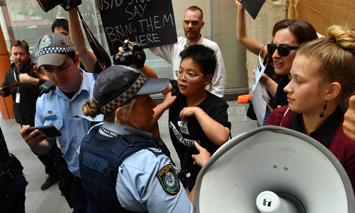 Police officers block refugee advocates' action at the Immigration and Department of Foreign Affairs and Trade building in Sydney on November 3, 2017.  Photo: AFP