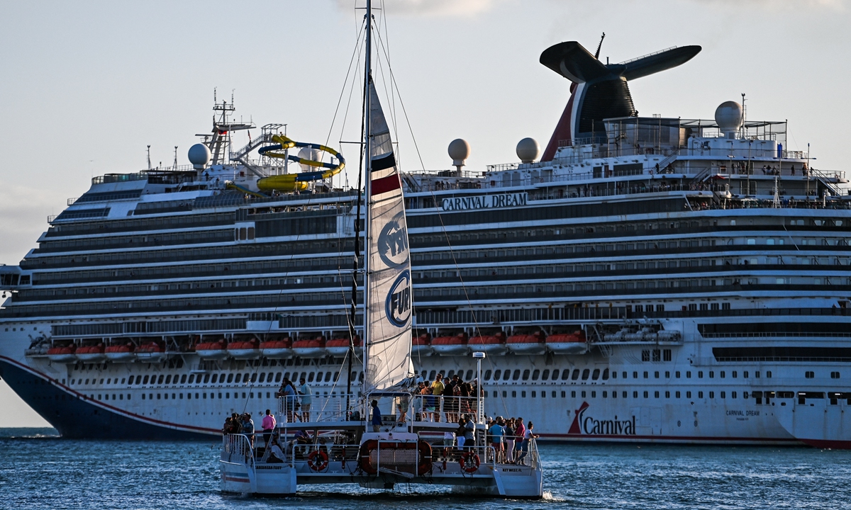 Tourists ride on a boat as the Carnival Dream cruise ship sails in Key West, Florida, on April 11, 2022. Photo: AFP