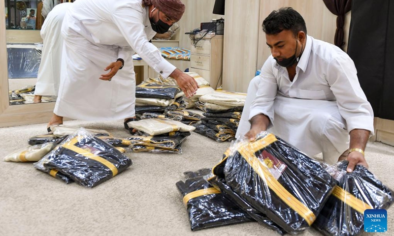Vendors arrange traditional dresses at a shop in preparation for the Eid al-Fitr festival in Doha, Qatar, April 19, 2022.(Photo: Xinhua)