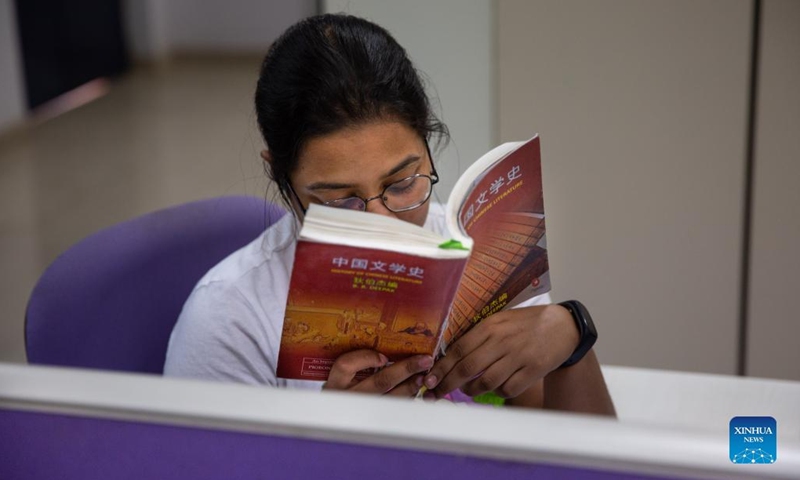 An Indian student of Chinese language course reads a book on Chinese literature in a library of the Center for Chinese and South East Asian Studies at Jawaharlal Nehru University (JNU) on the United Nations Chinese Language Day, in New Delhi, India, April 20, 2022. The UN Chinese Language Day is observed on April 20 every year since 2010, celebrating the language's contribution to the world while encouraging more people to learn it.(Photo: Xinhua)