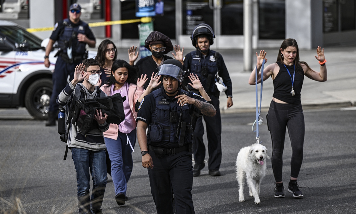 Police escort people fleeing the scene of a reported shooting in Washington, DC, on April 22, 2022. Since 2022, there have been at least 147 mass shootings and 13,000 deaths in the US, according to the Gun Violence Archive. Photo: AFP
