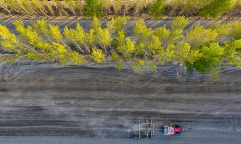 Aerial photo taken on April 19, 2022 shows a seeding machine guided by the BeiDou Navigation Satellite System working in a cotton field in a farm of a division of Xinjiang Production and Construction Corps in northwest China's Xinjiang Uygur Autonomous Region.