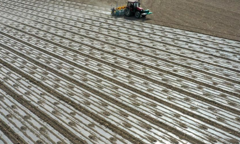 Aerial photo taken on April 19, 2022 shows a seeding machine guided by the BeiDou Navigation Satellite System working in a cotton field in a farm of a division of Xinjiang Production and Construction Corps in northwest China's Xinjiang Uygur Autonomous Region.