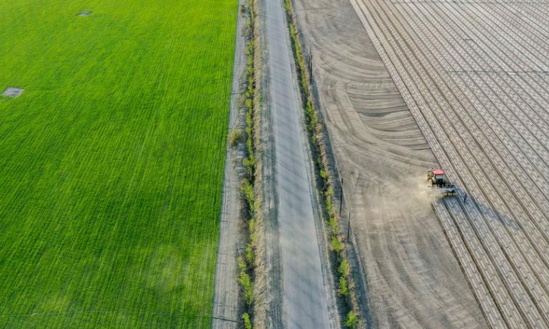 Aerial photo taken on April 19, 2022 shows a seeding machine guided by the BeiDou Navigation Satellite System working in a cotton field in a farm of a division of Xinjiang Production and Construction Corps in northwest China's Xinjiang Uygur Autonomous Region.