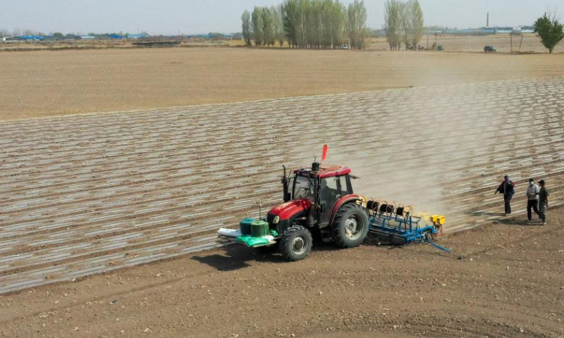 Aerial photo taken on April 19, 2022 shows a seeding machine guided by the BeiDou Navigation Satellite System working in a cotton field in a farm of a division of Xinjiang Production and Construction Corps in northwest China's Xinjiang Uygur Autonomous Region.