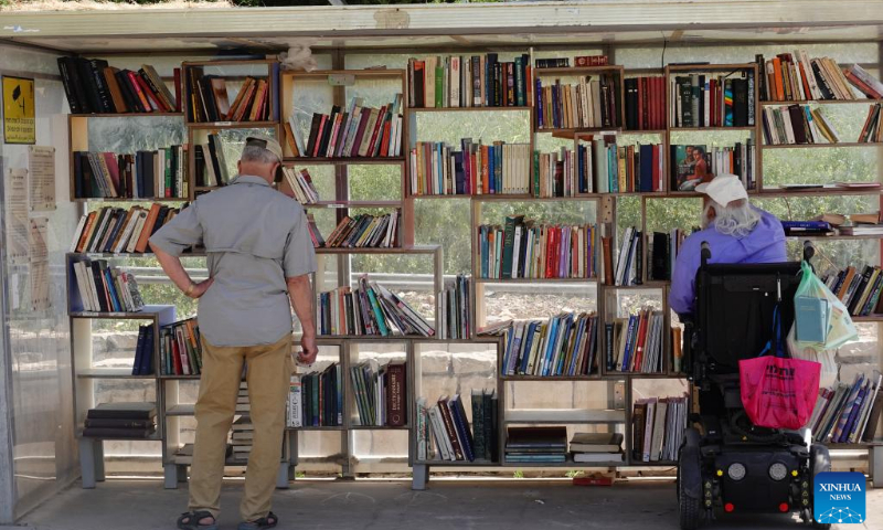 People select books at a street library in Jerusalem ahead of the World Book Day, on April 22, 2022. April 23 marks the World Book Day. (Photo: Xinhua)
