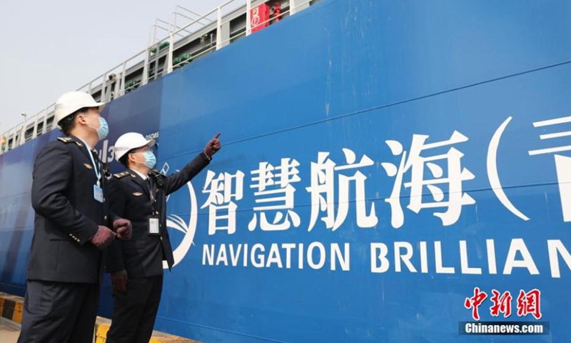Staff conduct final inspection to Zhi Fei, China's first autonomous 300TEU container merchant ship, before its maiden voyage in Qingdao, east China's Shandong Province, April 22, 2022. (Photo: China News Service/Zhang Jingang)