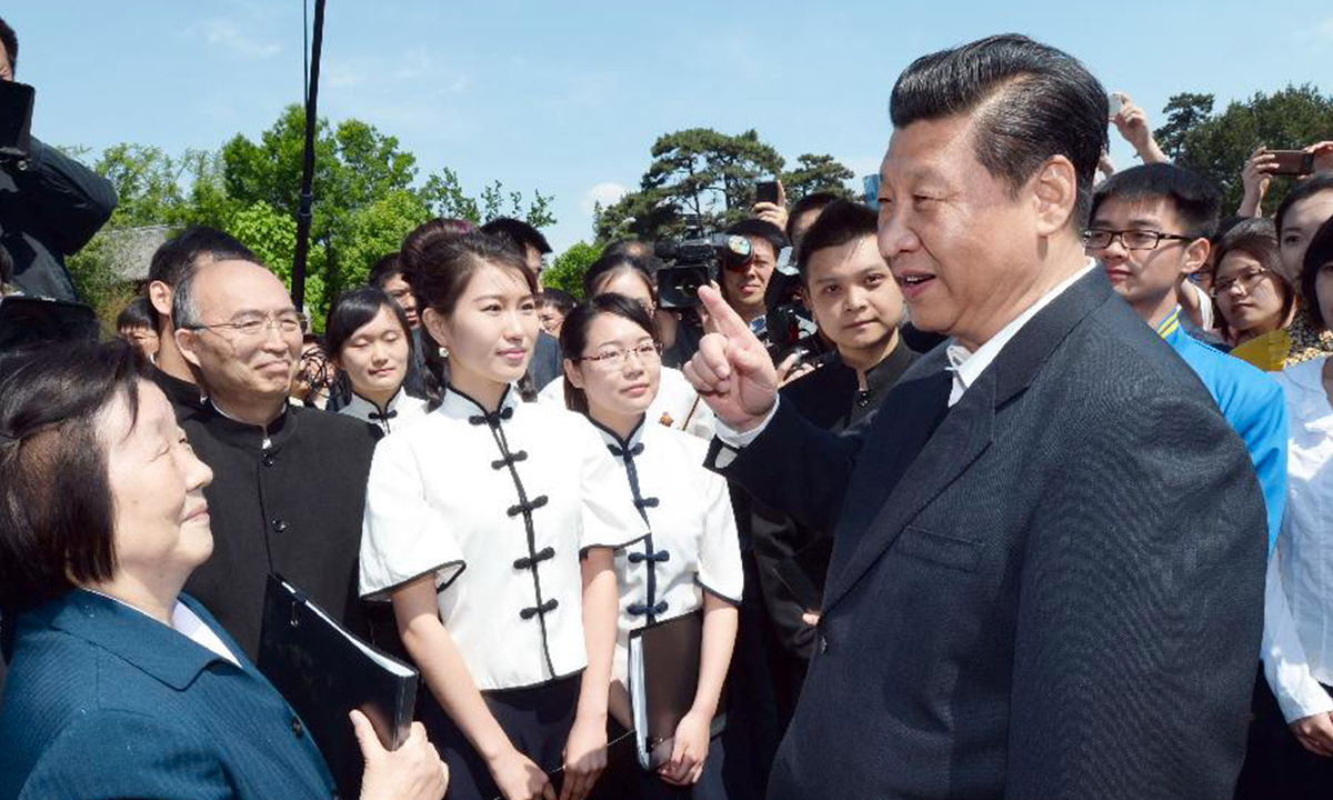 President Xi Jinping talks with faculty members and students while attending a campus poetry recital marking the 95th anniversary of the May 4th Movement of 1919 at Peking University (PKU) in Beijing on May 4, 2014. Photo: Xinhua