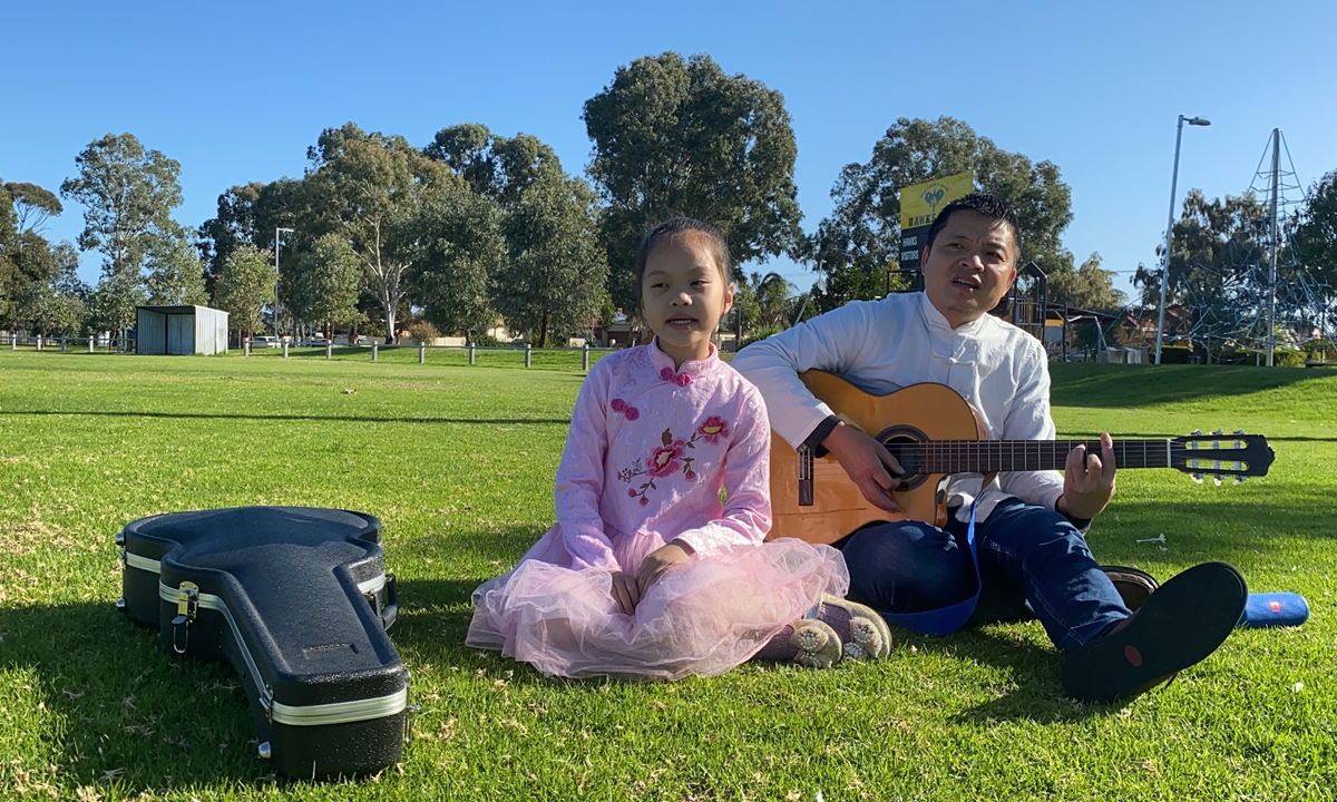 Abao (right) and his daughter Emily sing on the lawn. Photo: Courtesy of Abao 