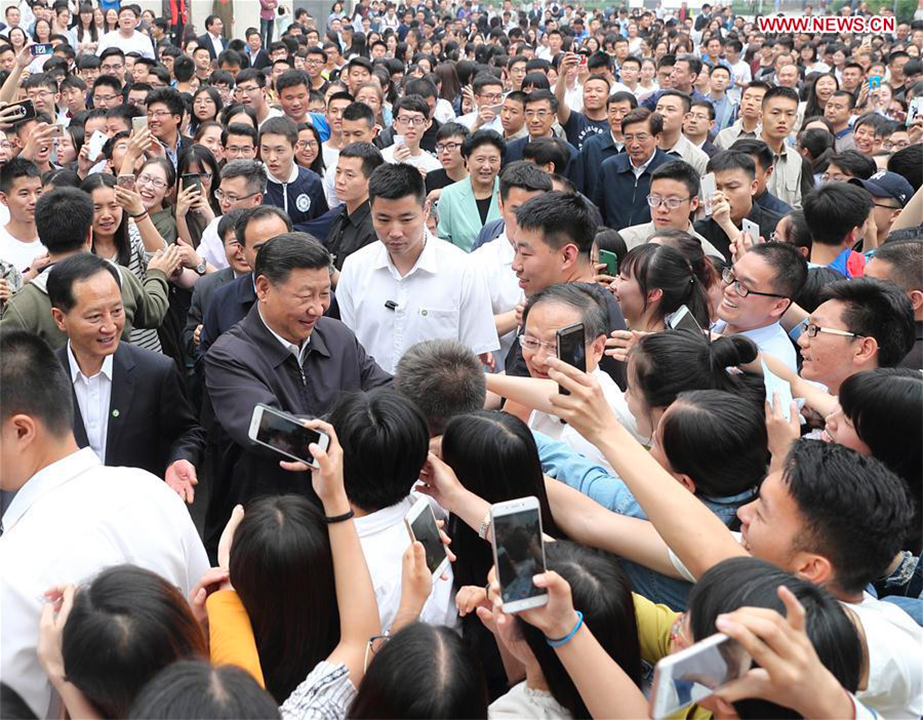 President Xi Jinping shakes hands with faculty members and students while inspecting China University of Political Science and Law in Beijing on May 3, 2017. Photo: Xinhua
