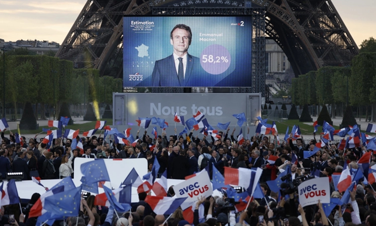 Supporters cheer after the victory of Emmanuel Macron in France's presidential election, at the Champ de Mars, in Paris, on April 24, 2022. Photo: AFP