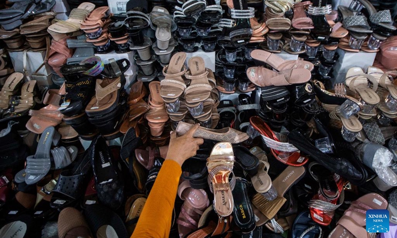 A woman chooses shoes ahead of Eid Al-Fitr at the Tanah Abang market, in Jakarta, Indonesia, on April 25, 2022.(Photo: Xinhua)