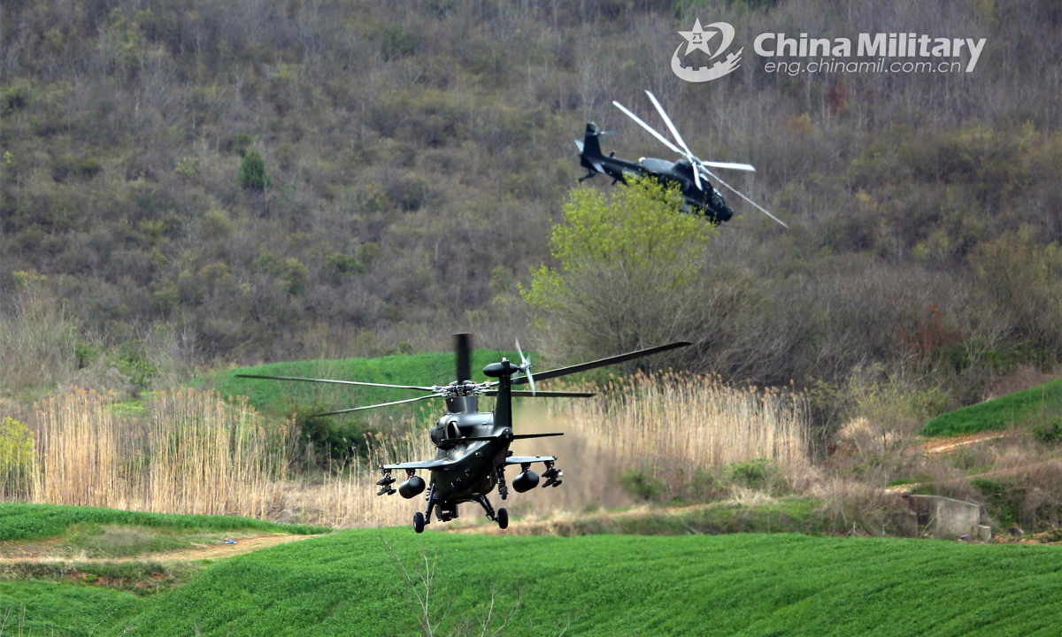 Two military helicopters attached to an army aviation brigade under the PLA 72nd Group Army fly at an ultralow altitude in the valley for a penetration mission in the tactical flight training on March 22, 2022. Photo: China Military