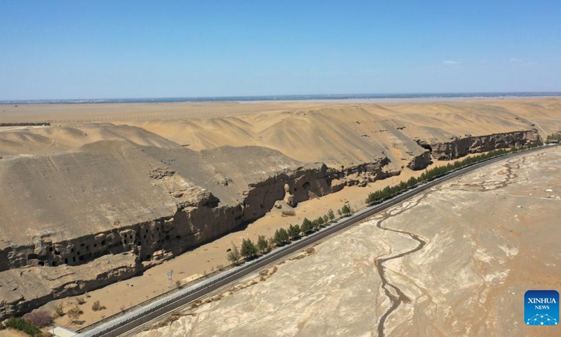 Aerial photo taken on April 18, 2022 shows the Mogao Grottoes in Dunhuang, northwest China's Gansu Province. Located in Dunhuang, northwest China's Gansu Province, the millennium-old Mogao Grottoes are home to a vast collection of Buddhist artworks which are considered the finest in existence -- more than 2,000 colored sculptures and 45,000 square meters of murals -- in 735 caves carved along a cliff by ancient worshippers.(Photo: Xinhua)