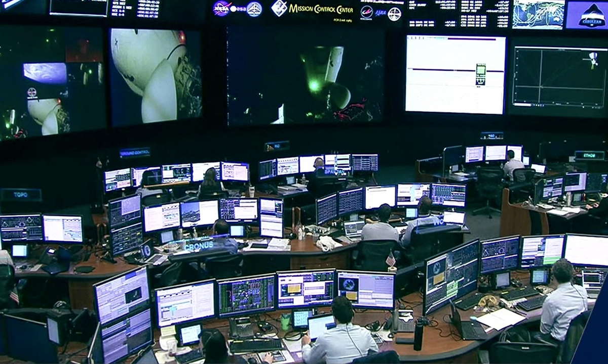 In this screengrab from a NASA TV broadcast, the SpaceX control room technicians in Hawthorne, California watch as the crew of the Axiom-1 mission undocks from the International Space Station on April 25, 2022. Photo: AFP