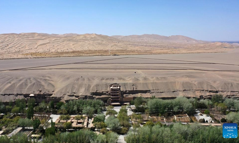 Aerial photo taken on April 18, 2022 shows the Mogao Grottoes in Dunhuang, northwest China's Gansu Province. Located in Dunhuang, northwest China's Gansu Province, the millennium-old Mogao Grottoes are home to a vast collection of Buddhist artworks which are considered the finest in existence -- more than 2,000 colored sculptures and 45,000 square meters of murals -- in 735 caves carved along a cliff by ancient worshippers.(Photo: Xinhua)