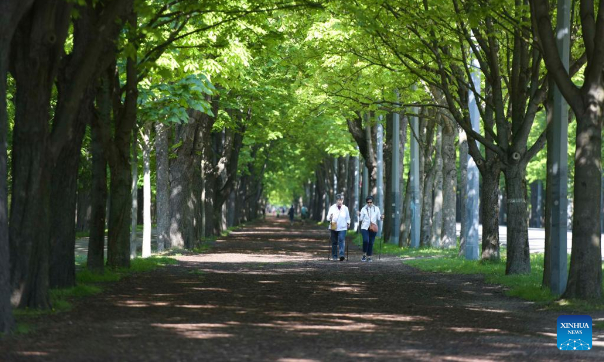 Citizens walk in Prater Hauptallee in Vienna, Austria on April 29, 2022. The famous Prater Hauptallee was awarded the World Athletics Heritage Plaque in the category of Landmark earlier this April.Photo:Xinhua