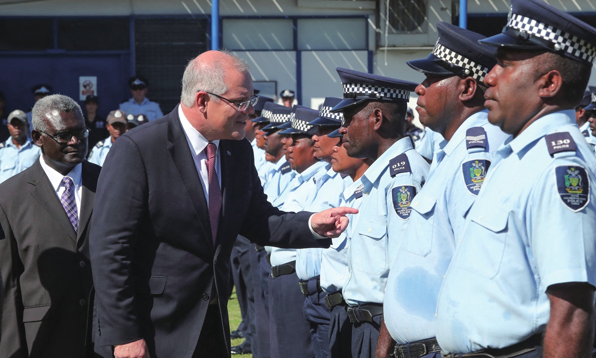 Australia's Prime Minister Scott Morrison and his Solomons Islands counterpart Manasseh Sogavare inspect the guard of honor at the Royal Solomons Islands Police Academy in Honiara on June 3, 2019. Photo: AFP