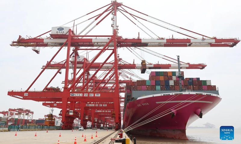 A container ship from Japan is seen at the container dock of Shanghai's Yangshan Port in east China, April 27, 2022. About 25,000 staff members stick to their posts in Shanghai port to guarantee water transportation and improve logistics efficiency amid challenges caused by the recent resurgence of COVID-19 in Shanghai.(Photo: Xinhua)