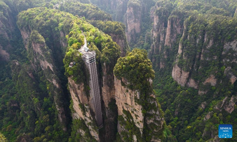 Aerial photo taken on April 19, 2022 shows the Bailong Elevator built onto the side of a huge cliff at the Wulingyuan scenic area in Zhangjiajie, central China's Hunan Province. Wulingyuan, a UNESCO World Heritage Site, is noted for its unique quartzite sandstone pillars and peaks across most of the site.(Photo: Xinhua)
