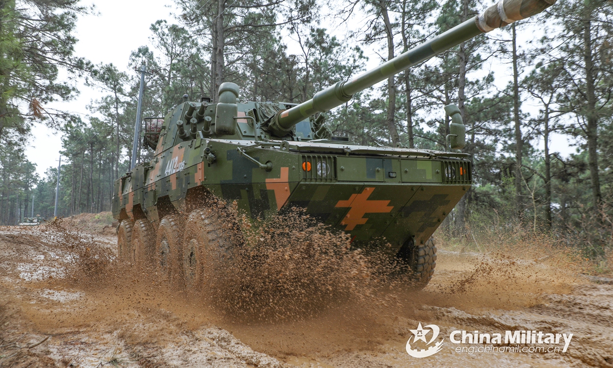 An armored vehicle attached to a brigade under the PLA 72nd Group Army rumbles through the muddy road in a driving assessment on March 26, 2022.Photo:China Military