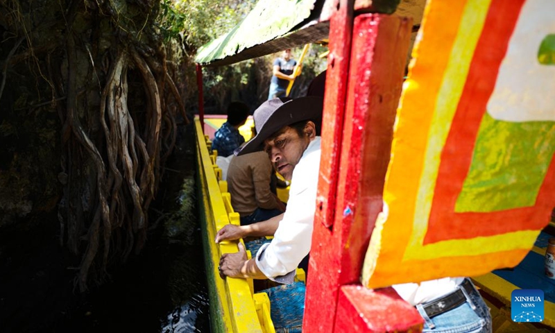 A man is seen on a trajinera on the lake of Xochimilco, in Mexico City, capital of Mexico, April 27, 2022. Xochimilco was declared in 1987 as World Heritage Site by the UNESCO. A tour on colorful trajineras along its waterways is one of the popular activities for tourists.Photo:Xinhua