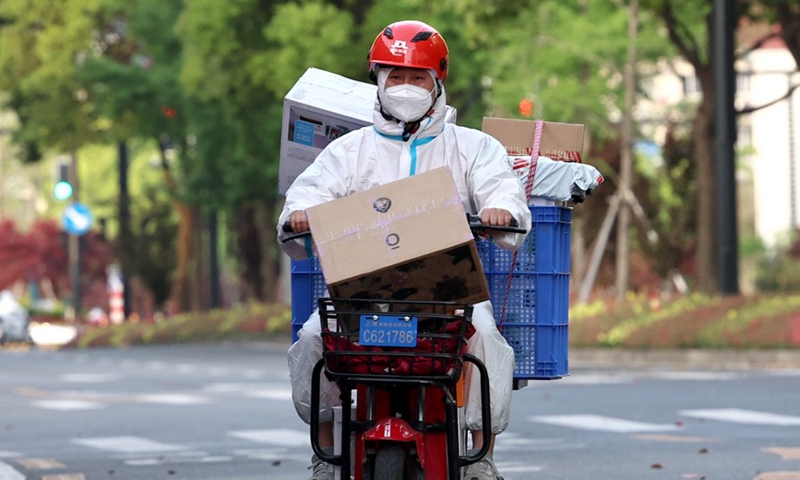 A delivery man with e-commerce giant JD.com from Xi'an, capital of northwest China's Shaanxi Province, is delivering goods in Hongkou District of Shanghai, east China, April 17, 2022.Photo:Xinhua