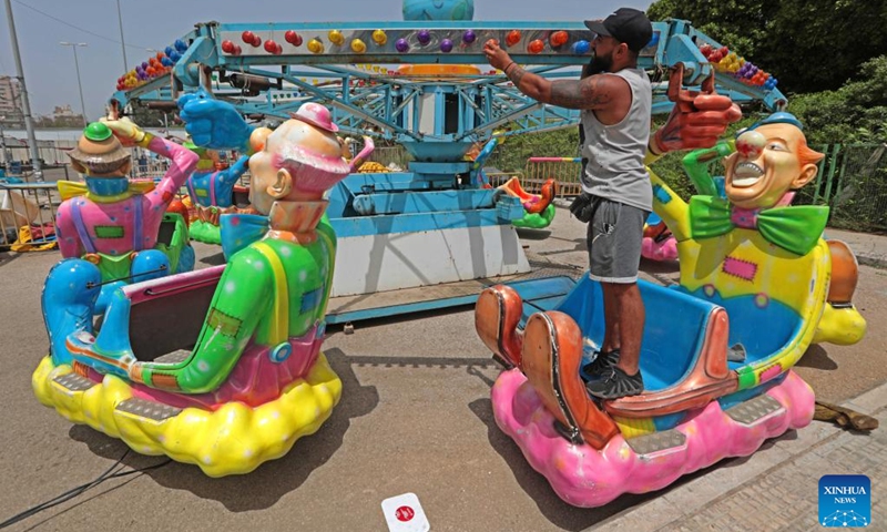 A worker prepares for the upcoming Eid al-Fitr at an amusement park in Beirut, Lebanon, on April 30, 2022. (Xinhua/Bilal Jawich)