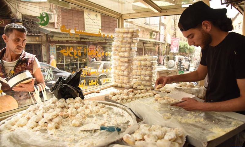 A worker makes Maamoul cookies, one of the popular sweets served on Eid al-Fitr, in Tripoli, northern Lebanon, on April 30, 2022. (Photo by Khaled Habashiti/Xinhua)