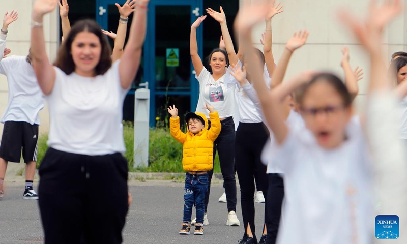 People dance during an event marking the International Dance Day which falls on April 29 in Bucharest, capital of Romania, on April 30, 2022. (Photo by Cristian Cristel/Xinhua)