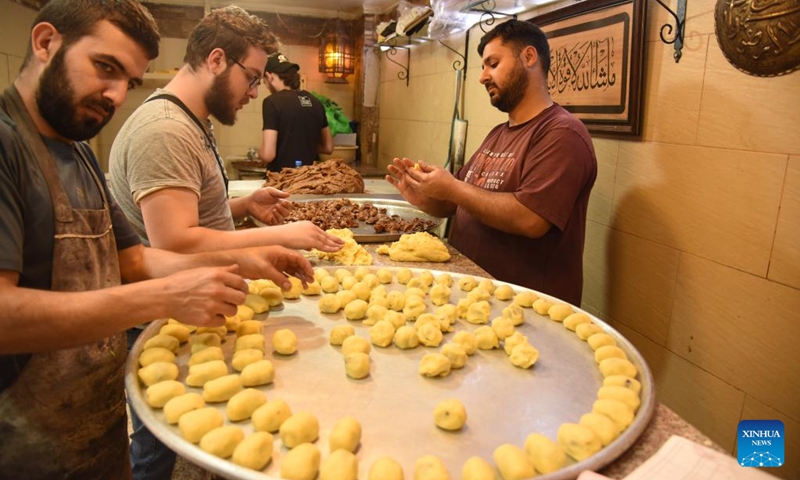 Workers make Maamoul cookies, one of the popular sweets served on Eid al-Fitr, in Tripoli, northern Lebanon, on April 30, 2022. (Photo by Khaled Habashiti/Xinhua)