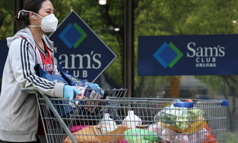 A customer walks past a Sam's Club warehouse store at Beicai Town in Pudong New Area, east China's Shanghai, May 2, 2022. Large retail companies in Shanghai have started to reopen their supermarkets amid the recent COVID-19 resurgence. (Xinhua/Chen Jianli)