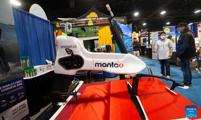 A man looks at a hydrofoil ebike during the 2022 Outdoor Adventure Show in Mississauga, the Greater Toronto Area, Canada, on May 1, 2022.Photo:Xinhua