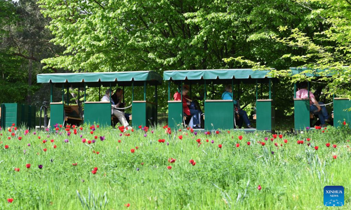 People take a mini train at Britzer Garten in Berlin, capital of Germany, May 6, 2022. Photo:Xinhua