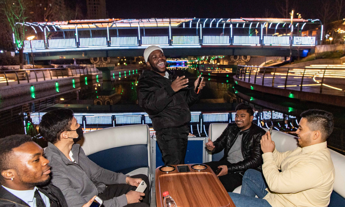 Foreigners enjoy the night view of Liangma River in December 2021. Photo: VCG