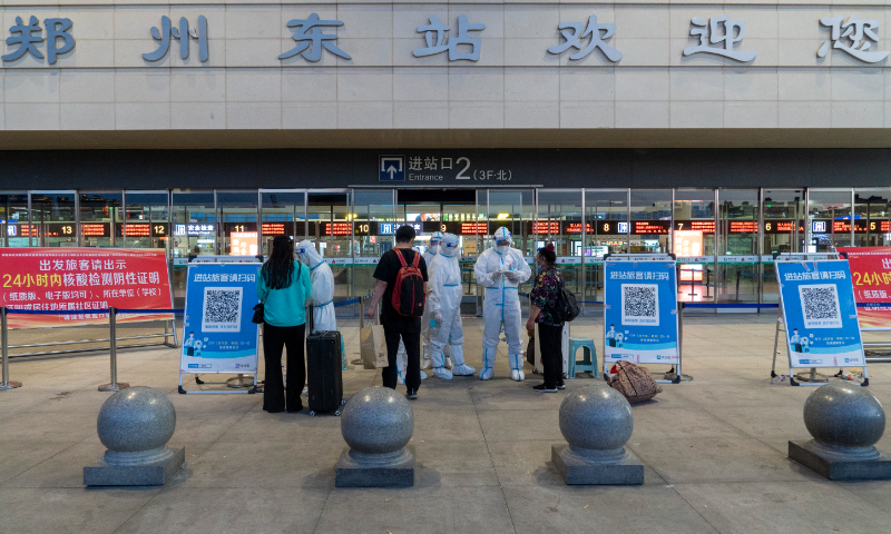 Anti-epidemic staff check travelers' health code at the entrance of Zhengzhou East railway station on May 4th, 2022. Photo: VCG