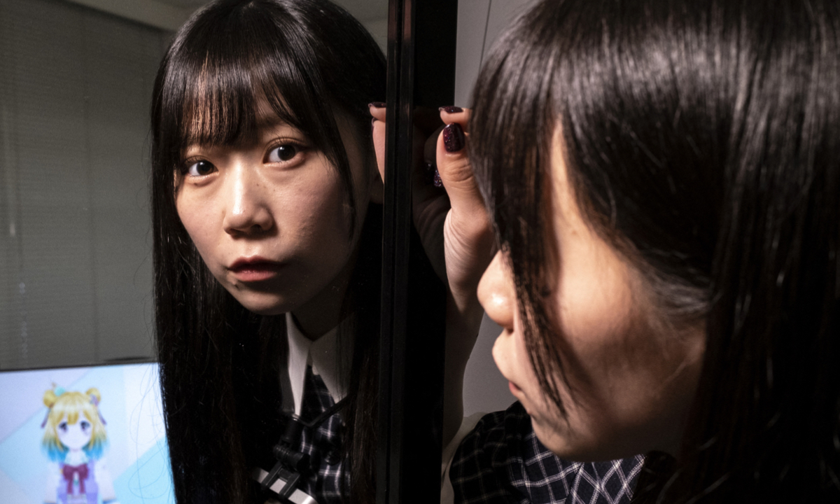 Mayu Iizuka, a virtual YouTuber who voices and animates a character called Yume Kotobuki, poses before a livestream at a studio in Tokyo on April 7, 2022. Photos: AFP
