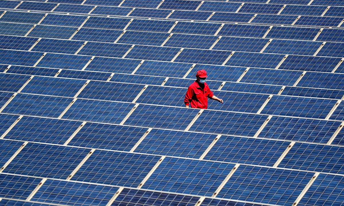 A technician inspects the rooftop photovoltaic (PV) power generation project of a company in Jimo district, East China's Shandong Province on May 4, 2022. Local authorities have been encouraging the construction of rooftop PV projects in recent years, soric firms can use clean el energy for production and operation. Photo: cnsphoto 