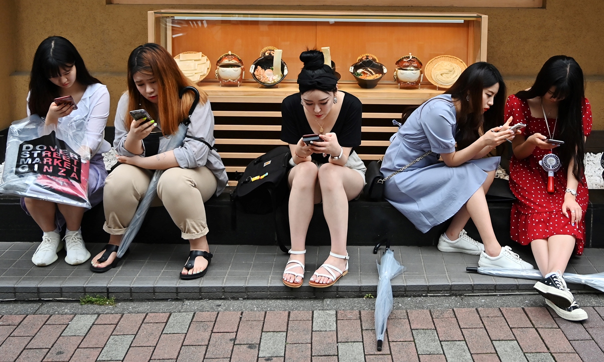 People wait in front of a restaurant in Tokyo's Ginza district on June 8, 2019. Photo: AFP