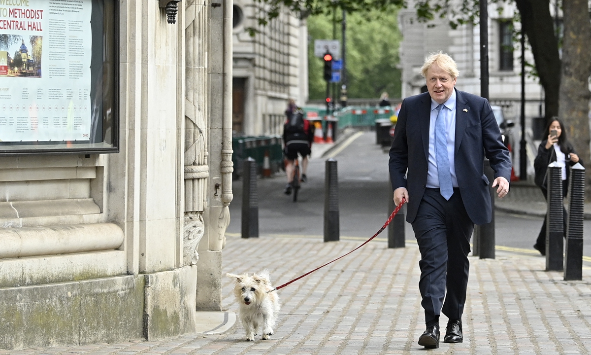 Britain's Prime Minister Boris Johnson arrives with his dog Dilyn at the Methodist Hall in central London to cast his vote in local elections on May 5, 2022. Polls opened across the UK in local and regional elections that could prove historic in Northern Ireland and heap further pressure on embattled Johnson. Photo: AFP
